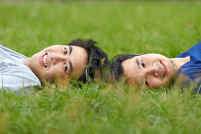 Buy stock photo Happy, relax and portrait of a gay couple in the grass for love, bonding and happiness in a park. Smile, lgbtq and Asian men in nature for a date, romance and relaxing together on a lawn or field