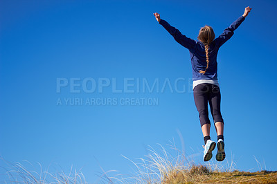 Buy stock photo Woman, workout and jump with freedom by space, sky background and outdoor in fitness mockup. Girl, mock up and training in nature for wellness, health and celebration leap for exercise achievement