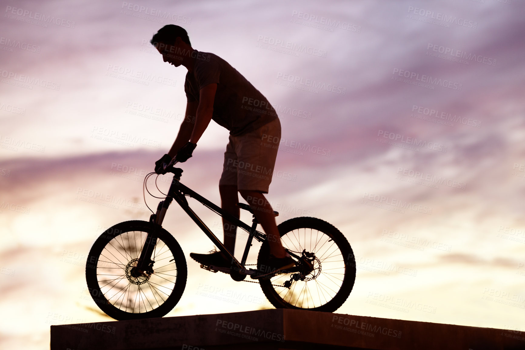 Buy stock photo Silhouette, sunset and cycling with man on bicycle for sports, adventure and fitness. Action, exercise and health with male cyclist riding on bmx bike for journey, urban or carbon neutral with mockup