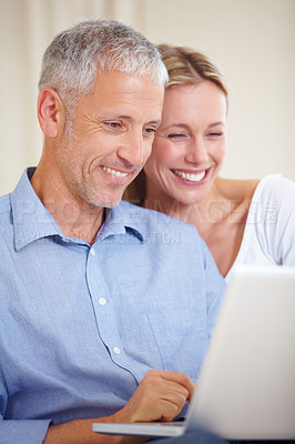 Buy stock photo Mature couple, laptop and smiling with video call, conversation and living room couch. Social media, technology and communication with family, man and woman with connection, streaming and happy
