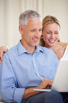 Buy stock photo Mature couple, laptop and video call with laugh, conversation and living room couch. Social media, technology and communication with family, man and woman with connection, streaming and happy
