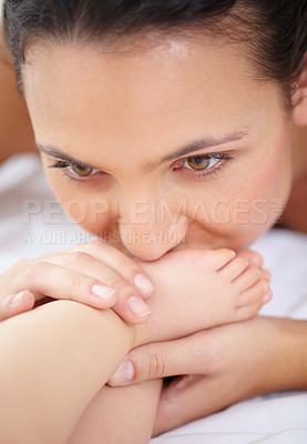 Buy stock photo Mother, baby and kiss feet on bed for love, care and relax in nursery room at home. Face, mom and closeup of foot of young kid for newborn development, healthy childhood growth and affection for bond
