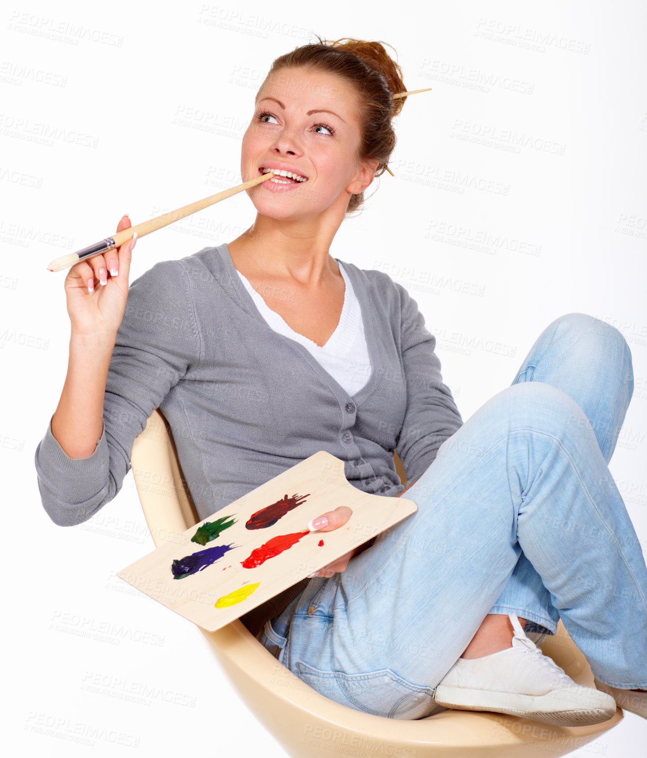 Buy stock photo Studio shot of a young woman holding a palette and brush looking for inspiration