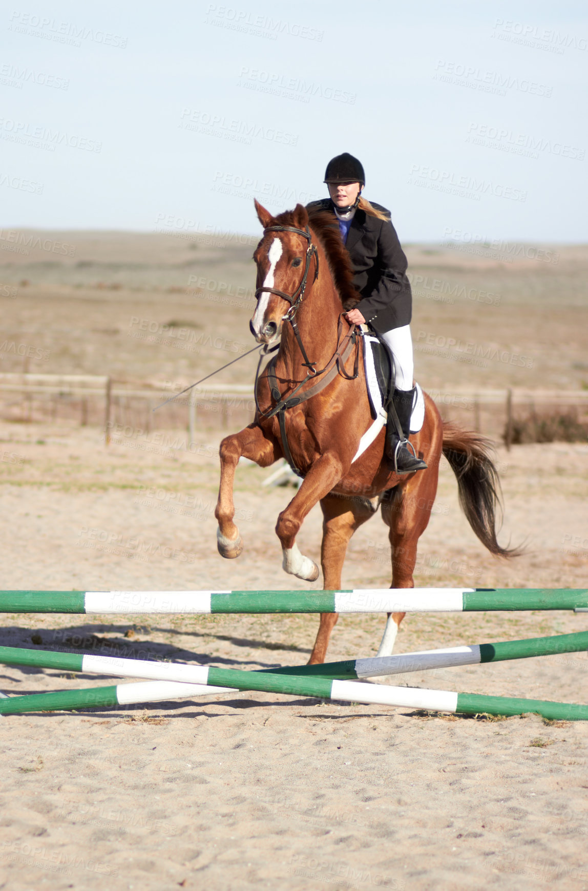 Buy stock photo Shot of a rider leading her horse over a jump