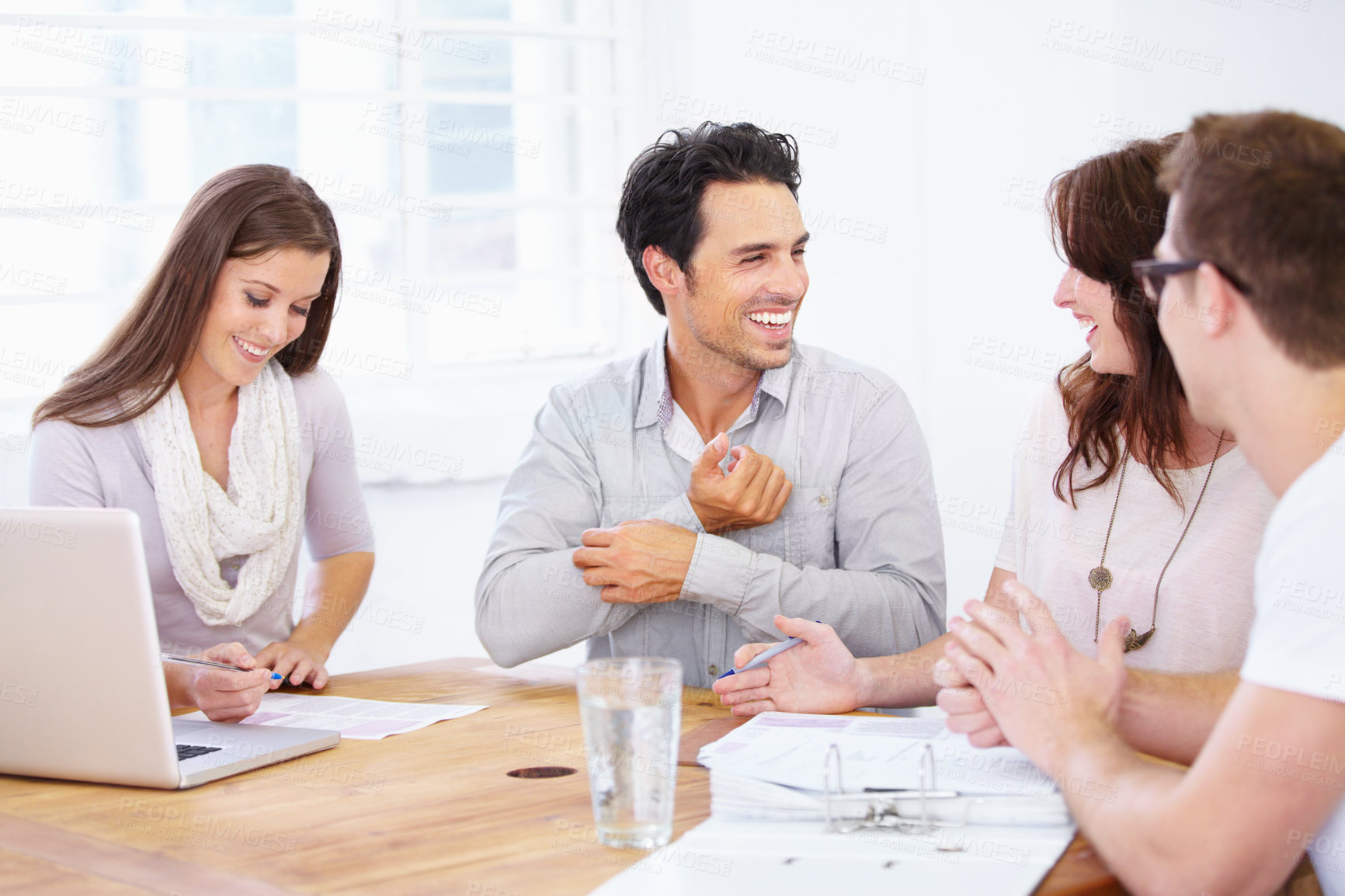 Buy stock photo Shot of a group of young design professionals sitting at a table and having a brainstorming session