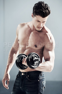 Buy stock photo A masculine male with no shirt on lifting weights