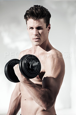 Buy stock photo A masculine male with no shirt on holding weights