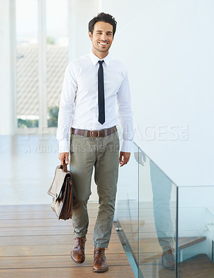 Buy stock photo Mission, walking and happy with a business man in a modern office or company at work. Mindset, smile and career with a handsome young male corporate employee arriving at his professional workplace