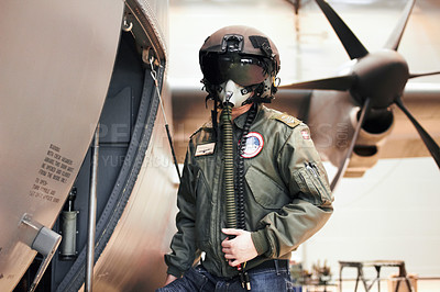 Buy stock photo A pilot standing in full gear next to his plane