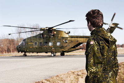 Buy stock photo Army, military or soldier man with a helicopter outdoor for transportation, Denmark war and pilot mission. Male person for combat, flight or air force service in camouflage uniform to watch or patrol