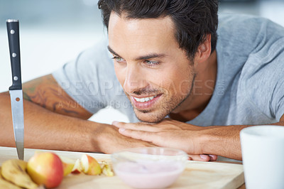 Buy stock photo Man, fruit and kitchen in morning breakfast diet or health nutrition, eating vitality or banana for protein. Male person, yogurt and apple detox meal for hungry vegan preparation, fiber or vitamins