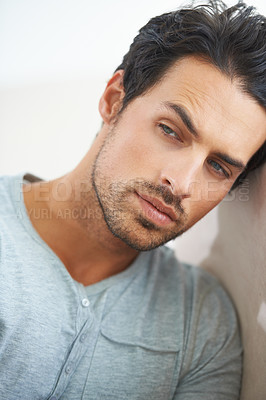 Buy stock photo Thinking, face or serious man brainstorming, wondering or looking curious while leaning against a wall. Chilling, easy or young male person alone, bored or waiting, thoughtful or confident expression