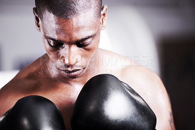 Buy stock photo A young boxer taking some time to visualize before a fight