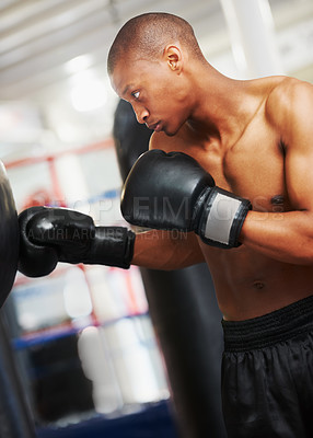 Buy stock photo Boxing, gloves and black man training in gym with fitness, power and workout challenge. Strong body, muscle and boxer in club, athlete fighting with bag for exercise and confidence in competition.