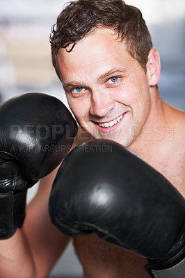 Buy stock photo Boxing, gloves and portrait of man with smile for fitness, power and training challenge in gym. Strong body, muscle and confidence, happy boxer or athlete with fist up and competition fight champion.
