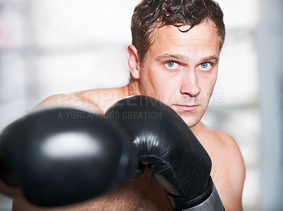 Buy stock photo Boxing, gloves and serious portrait of man with fitness, power and training challenge in gym. Strong body, muscle and confidence, boxer or athlete with fist up and fearless for competition fight.
