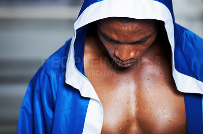 Buy stock photo Black man, robe and boxing champion getting ready for fight, challenge or sports competition at gym or ring. Serious African male person, fighter or boxer in preparation for MMA match or game start