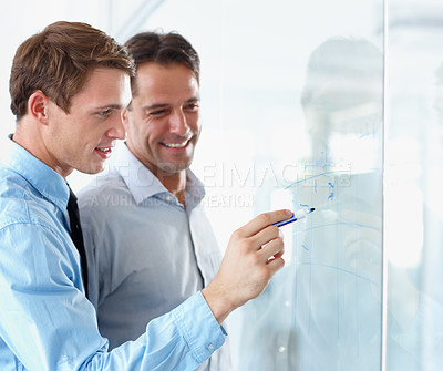 Buy stock photo Collaboration, planning and whiteboard with business men in the office, working together on company strategy. Our vision, mission and teamwork with male colleagues or employees writing while at work