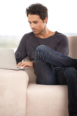 Buy stock photo Relax, laptop and online with man on sofa for social media, networking and connection. Website, streaming and digital with person in living room at home for remote work, research and technology