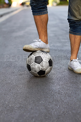 Buy stock photo Ready, street and feet of a person for soccer, game and training for sports. City, sneakers and legs of a man with a football for sport, exercise and urban fitness in the road while playing a match