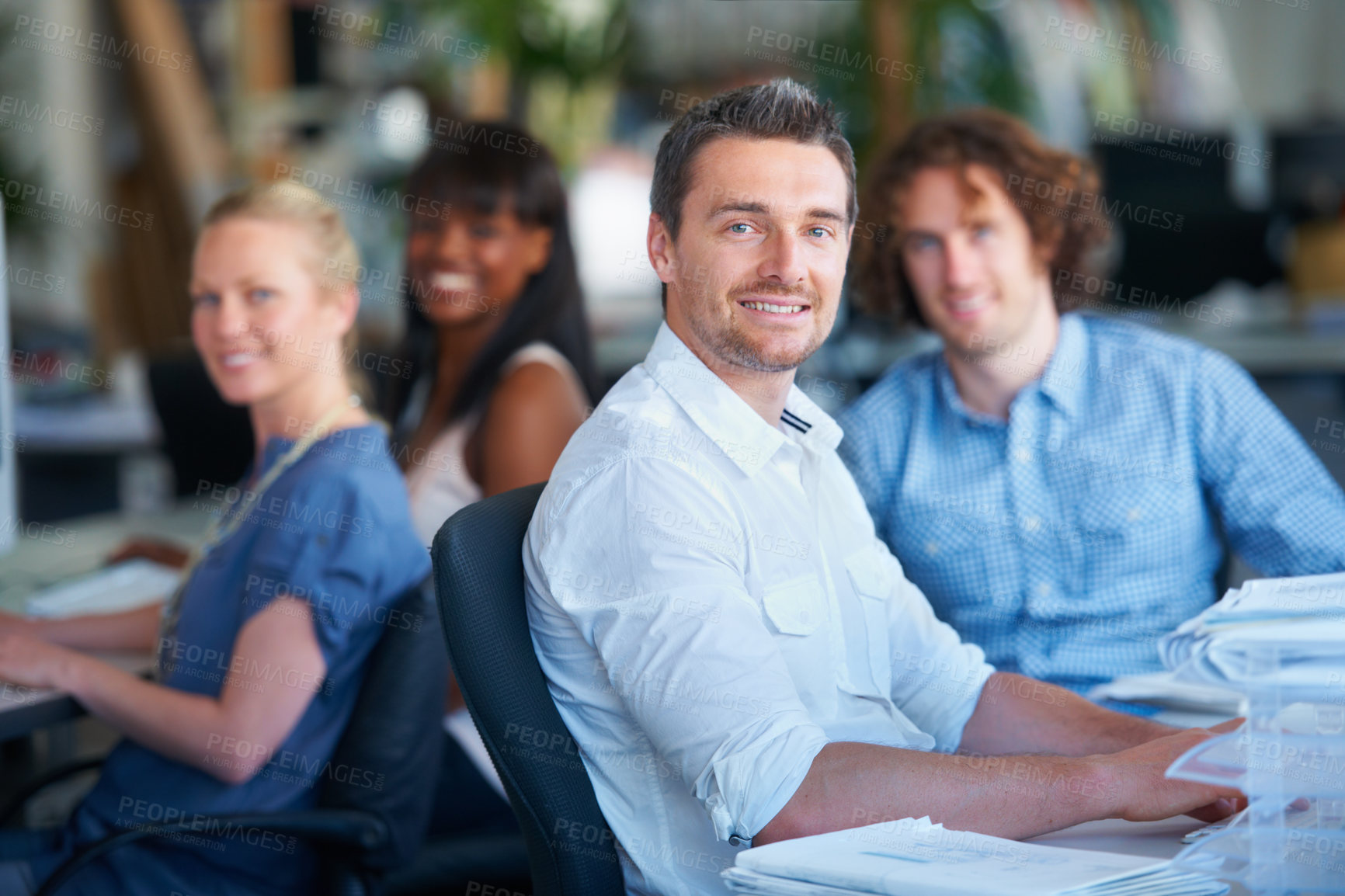 Buy stock photo Cropped shot of four businesspeople sitting in the office