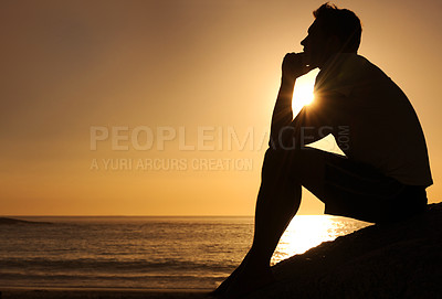 Buy stock photo Silhouette of a thoughtful man sitting by the ocean - copyspace