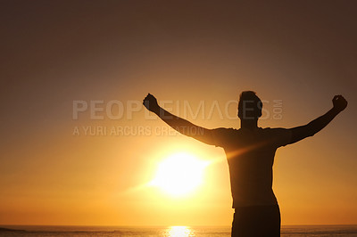 Buy stock photo Silhouette of a man with his arms outstretched with the sunset in front of him