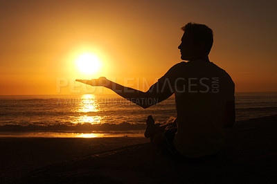 Buy stock photo Silhouette of a man holding up the palm of is hand so the sun 'rests' in it