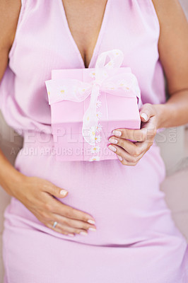 Buy stock photo Cropped shot of a pregnant woman holding a gift