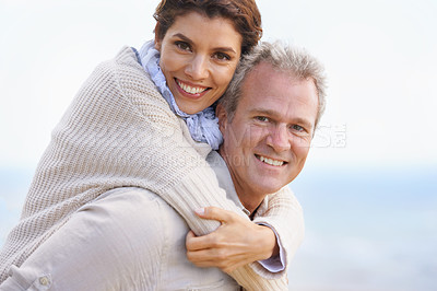 Buy stock photo Mature couple, portrait and piggy back on vacation, airplane hands and happiness for holiday. Man, woman and bonding together with smile, marriage and commitment with affection, joyful and blue skies