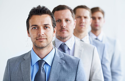 Buy stock photo Men, portrait and serious for future finance career, standing and ready for job interview. Worker, corporate accountant in suit or professional in workplace, colleagues in background and confident