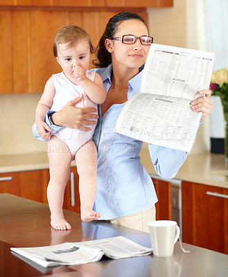 Buy stock photo Woman, newspaper and baby while reading in kitchen with headline or article. Single mother, glasses and little girl while multitasking or juggling work from home, productivity and job with childcare