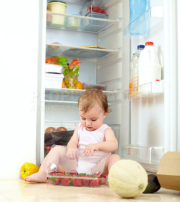 Buy stock photo Toddler, little girl and fruit from fridge in kitchen for eating, hunger or curiosity of container. Youth, child and busy with organic, fresh and snack with strawberry with development of motor skill