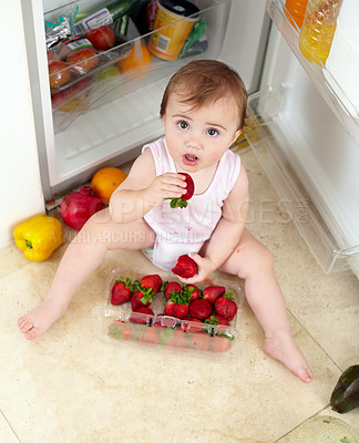 Buy stock photo Toddler, little girl and strawberry for eating in kitchen with open, fridge and door with above view. Youth, kid and hunger for fresh, organic and fruit for healthy, balanced or snack for development