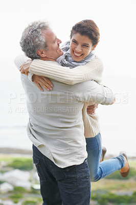 Buy stock photo Couple, face and laughing outdoor with hug for romance, love and relationship in nature with date. Mature, man and woman or embrace with happy, playful and trust for bonding, honeymoon and support 