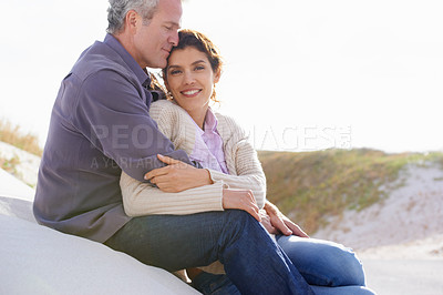 Buy stock photo Couple, face and smile outdoor with hug for romance, love and relationship on beach with relaxing. Mature, man and woman or embrace with happy, peace and comfort for bonding, honeymoon and support 