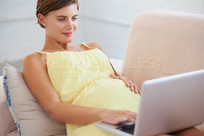 Buy stock photo Relax, pregnant and woman on laptop in house living room for childcare website, information or reading email. Happy, mother or person on home sofa with technology, research and pregnancy health blog