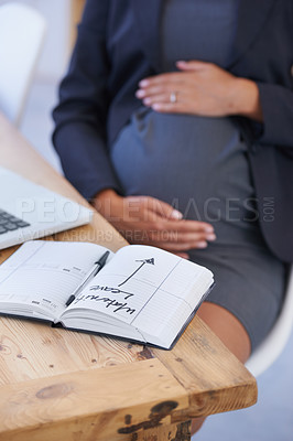 Buy stock photo Woman, pregnant and maternity date in book for work break, childcare or waiting for motherhood. Female person, stomach and hands as professional employee for career relax, note for infant schedule