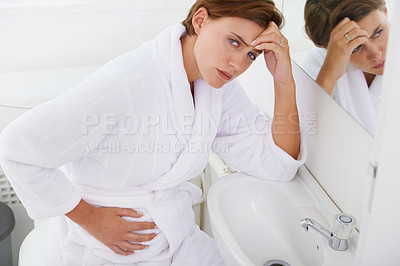 Buy stock photo Nausea, pregnant woman and morning sickness in bathroom, unhappy and hand on stomach. Mirror reflection, moody and frustrated with illness, pregnancy and struggling with migraine pain on sink