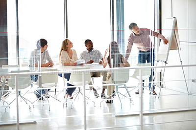 Buy stock photo Shot of a group of business colleagues in a boardroom meeting