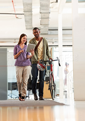 Buy stock photo Full length shot of a handsome bike messenger in an office