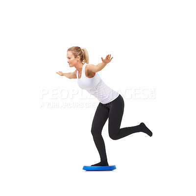 Buy stock photo Balance, health and workout with woman on disk in studio for fitness, body or exercise. Wellness, challenge and training with female person on white background for flexibility, smile or aerobics