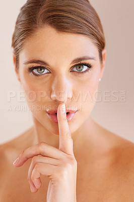 Buy stock photo Beauty secret, portrait or studio woman with confidential skin wellness routine, facial cosmetics or skincare whisper. Face makeup, emoji hush gesture or dermatology model silence on beige background