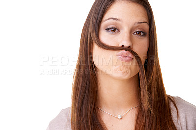 Buy stock photo Funny, portrait and woman with hair as a mustache in studio, white background or model with confidence. Person, pouting and posing with hairstyle, beauty or silly girl with crazy expression or face
