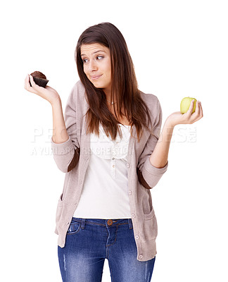 Buy stock photo Confused, decision and apple or muffin with a woman in studio isolated on a white background for food choice. Doubt, diet or nutrition with an unsure young person holding fruit and dessert options