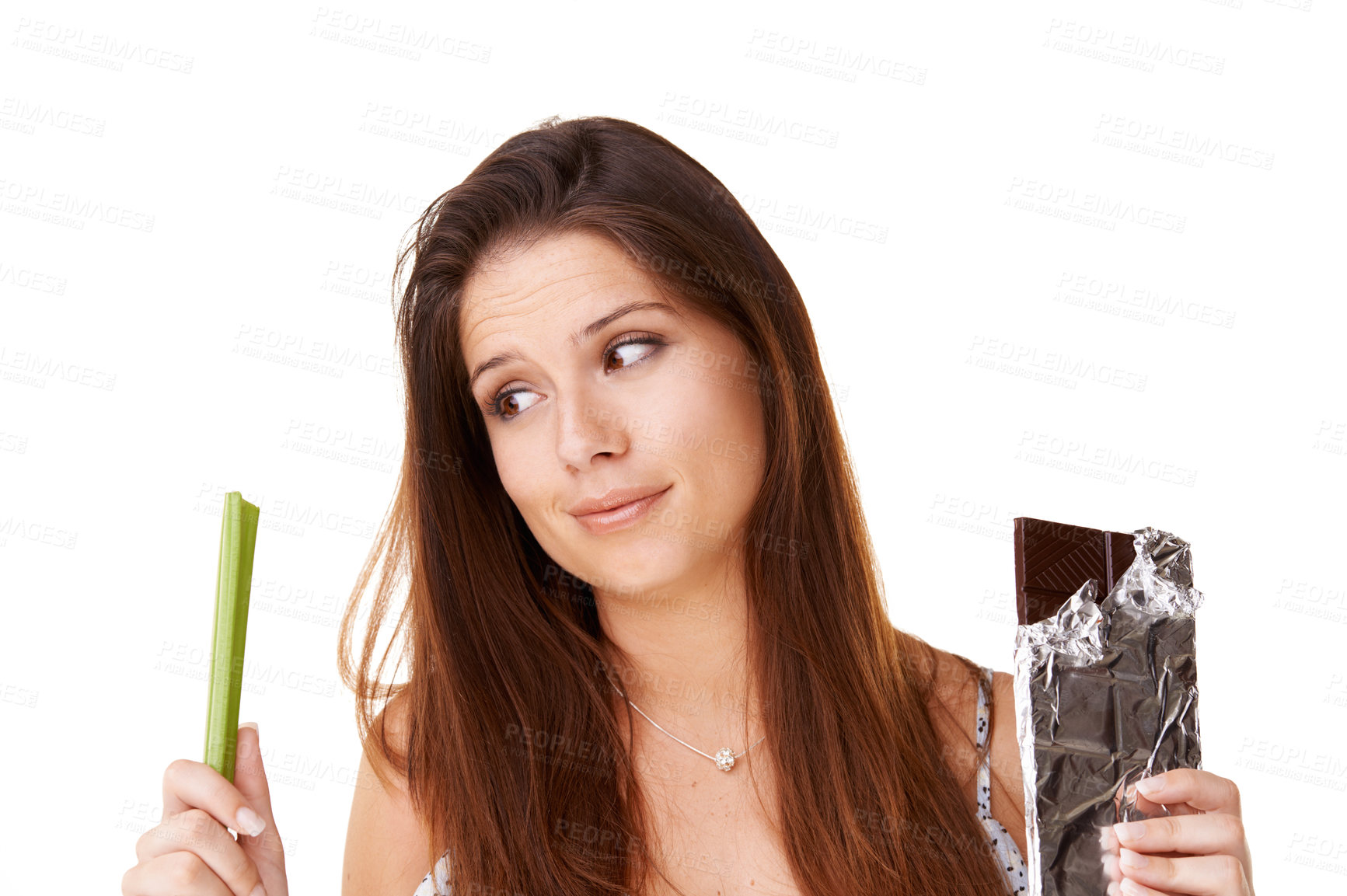 Buy stock photo Decision, celery and chocolate with woman, choice and girl isolated on a white studio background. Nutrition, person and model with candy, vegan or diet plan with health, wellness and sweet with doubt