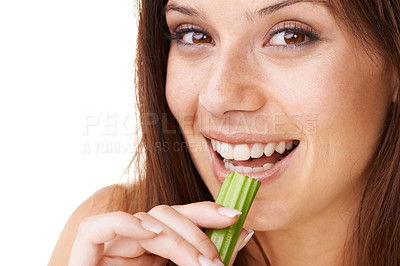 Buy stock photo Portrait of a beautiful young woman eating a stick of celery