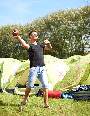 Buy stock photo Man throw ball, camping and smile in nature outdoor at music festival, party carnival or celebration event in summer. Sports, play and person for rugby at tent, exercise game and happy to travel 