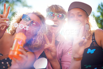Buy stock photo Portrait, peace sign and happy friends in sunglasses outdoor, blowing bubbles and funny laugh together in summer. Face, women and group of girls with v hand gesture, excited and lens flare in nature