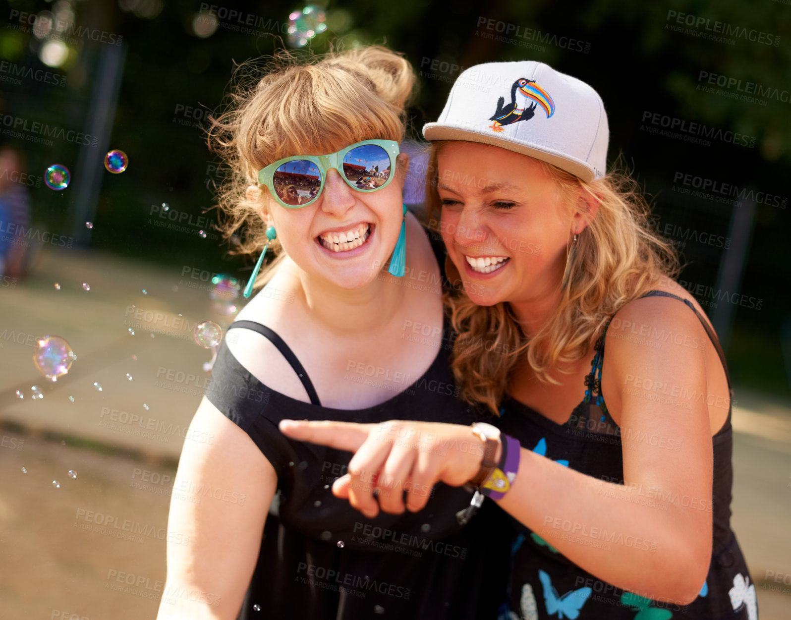 Buy stock photo Smile, friends and portrait of bubbles outdoor in nature, fun game at festival or freedom in summer. Face, happy girls and women with soap, cool sunglasses at party celebration and pointing together